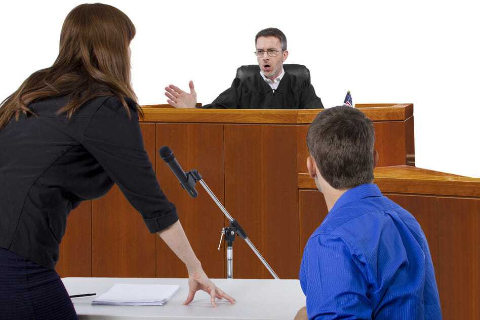 defendant with lawyer speaking to a judge in the courtroom trial