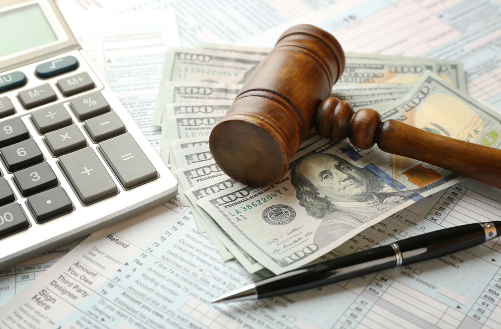 Judge's,Gavel,And,Dollar,Banknotes,On,Income,Tax evasion
